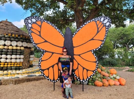 mother and kids in Dallas Arboretum Pumpkin Village One of the monthly events in Dallas