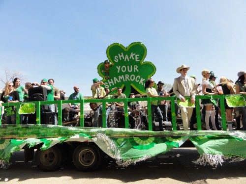 people in the parade in green vehicle in Dallas One of the monthly events in Dallas