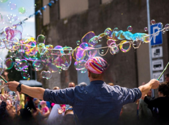 A magician blowing bubbles in state fair of Texas