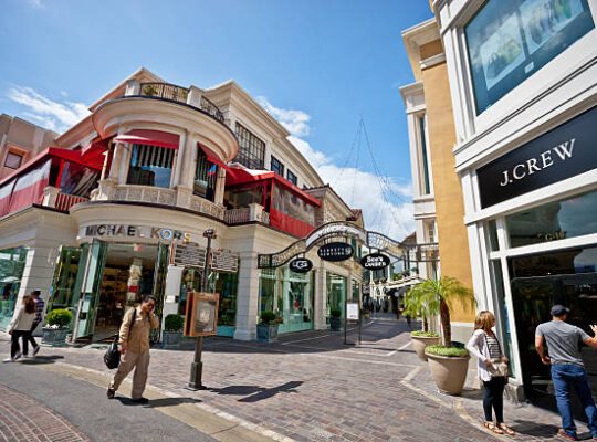 Exterior view of the J.Crew Outlet in Dallas, Texas, featuring a modern storefront design with large windows and prominent branding, set in a bustling shopping area.