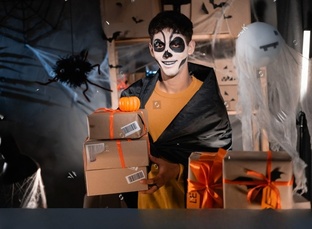 boy dressed for Halloween in ghost costume.