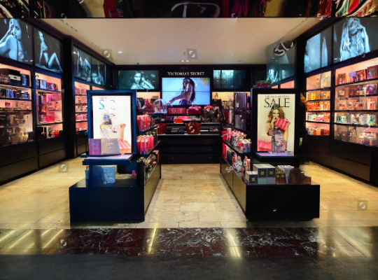 Interior view of the Victoria's Secret Outlet in Dallas, Texas, showcasing stylish lingerie displays, cozy fitting rooms, and vibrant store decor.