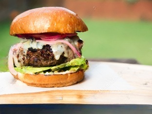 Angus beef burgers topped with avocado and jalapeños