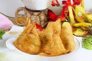 Samosas crispy pastries stuffed with spiced potatoes, peas, or meat, served with chutneys.