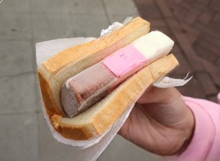 Delicious ice cream sandwiches from a Dallas food truck, featuring creamy ice cream sandwiched between freshly baked cookies, with colorful sprinkles on the sides.