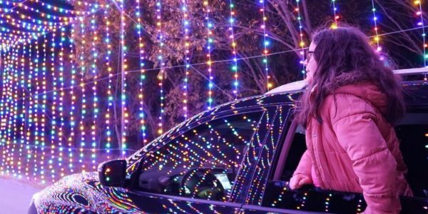 A girl watching lights at Prairie lights(grand prairie) from car window