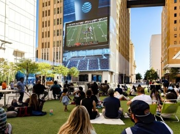 people enjoying outdoor movie in AT&T discovery disttrict in Dallas