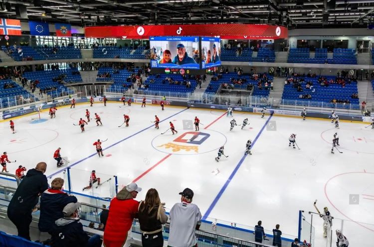 Indoor hockey game with players on the ice surrounded by stadium seating filled with spectators, one of the activity from the Dallas winter bucket.